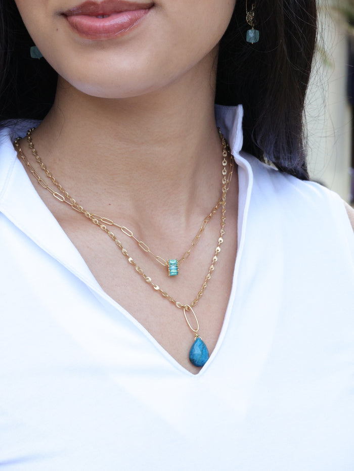 Aqua rondel necklace paired with jewelry from the nh Aqua Gold collection on model