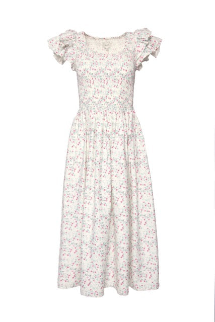 The Hattie Dress in Pansy Trellis by Ivy City Co is a nursing and maternity friendly cotton dress with a fitted bodice, ruffled short sleeves, and a flared skirt in pink, blue, and green florals on crisp white.