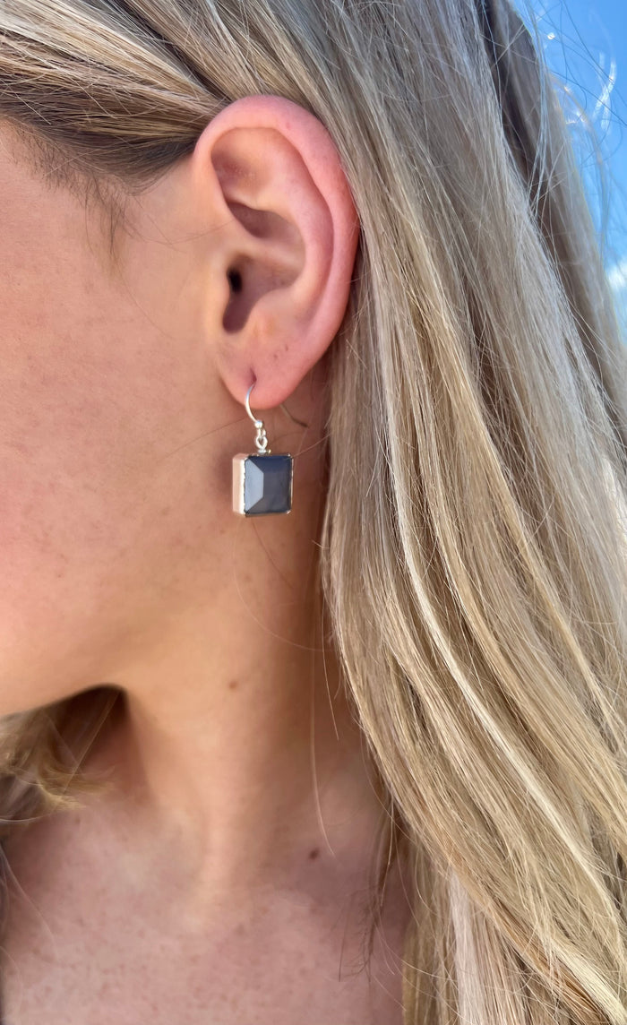 Shorter style grey stone square shaped with silver detailing in ear