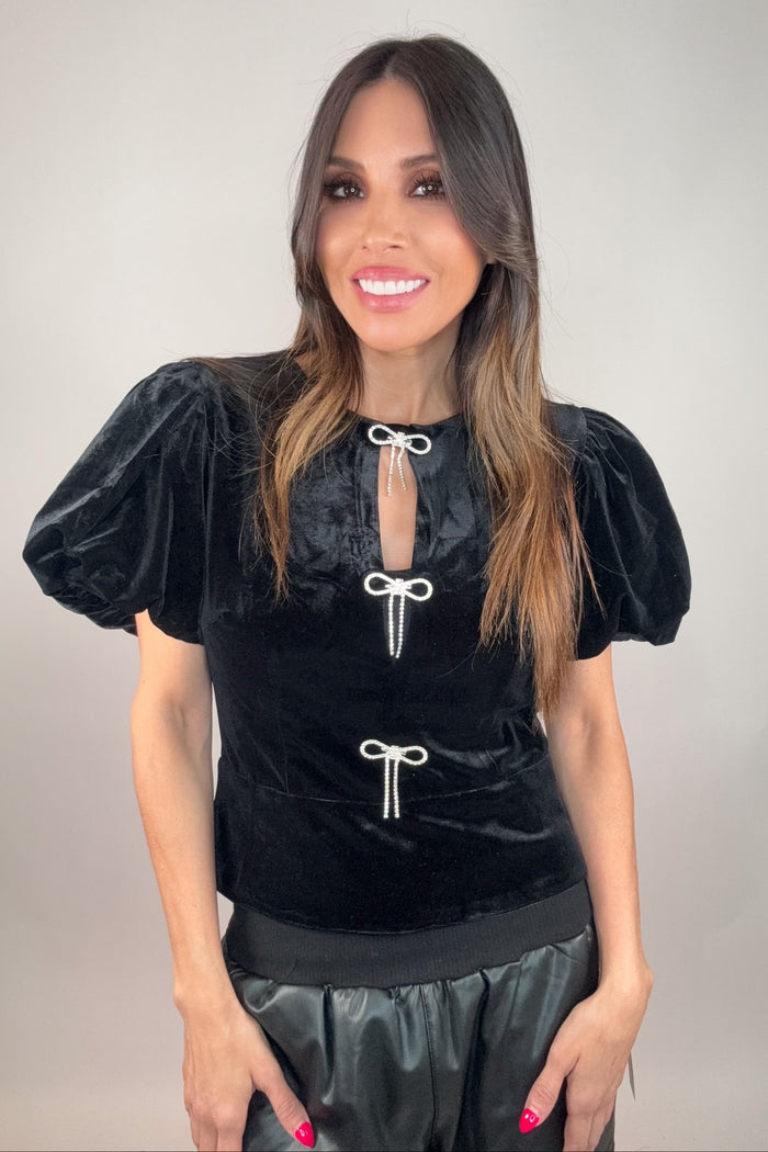 Style the Rhinestone Bow Cutout Velvet Puff Sleeve Top exclusively at Born To Glam
