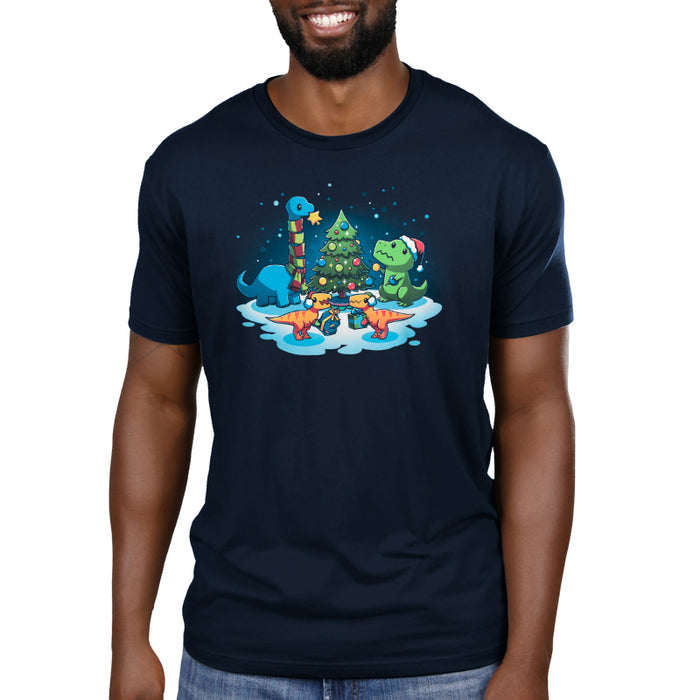 Premium Cotton T-shirt_TeeTurtle navy blue A Very Dino Christmas featuring dinosaurs celebrating around a decorated Christmas tree with snow on the ground and dinosaurs holding presents.