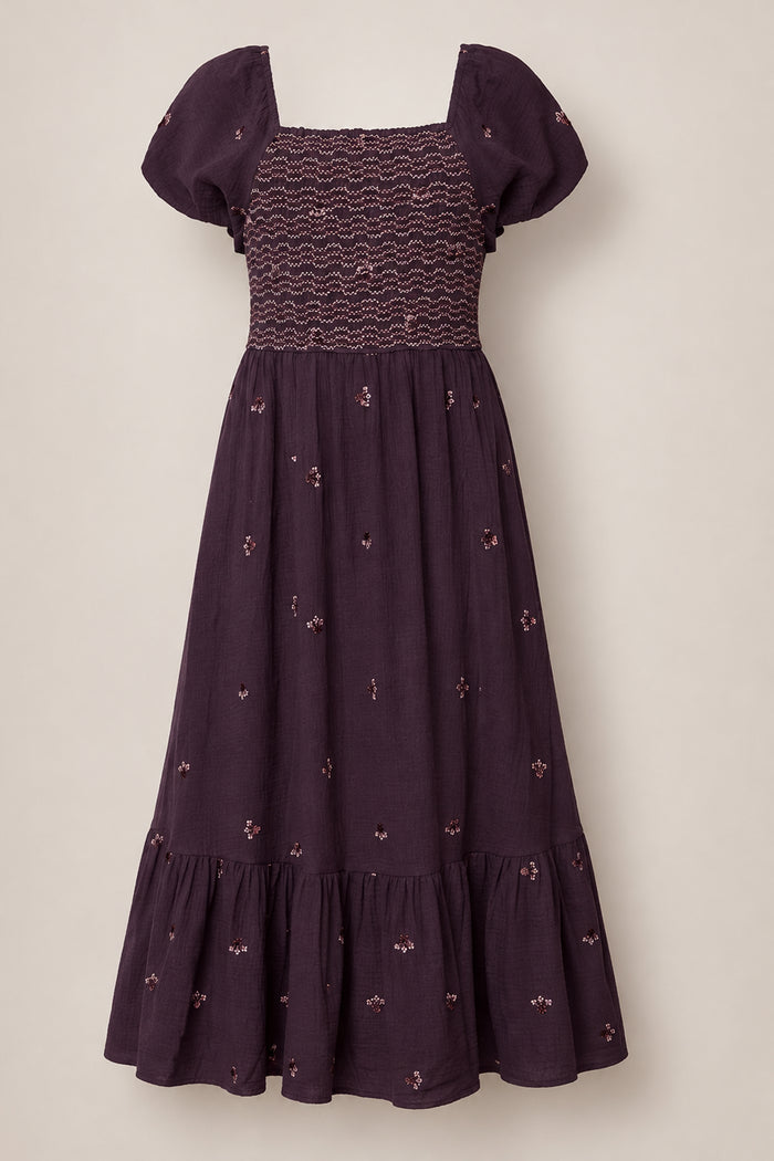 Aubergine Embroidered Gauze Acantha Dress by Ivy City Co featuring short sleeves, a smocked bodice, square neckline, and delicate embroidered floral patterns throughout. This midi-length dress includes a subtle ruffle hem and gently flared skirt, designed with a maternity-friendly fit for comfort and style at every stage.