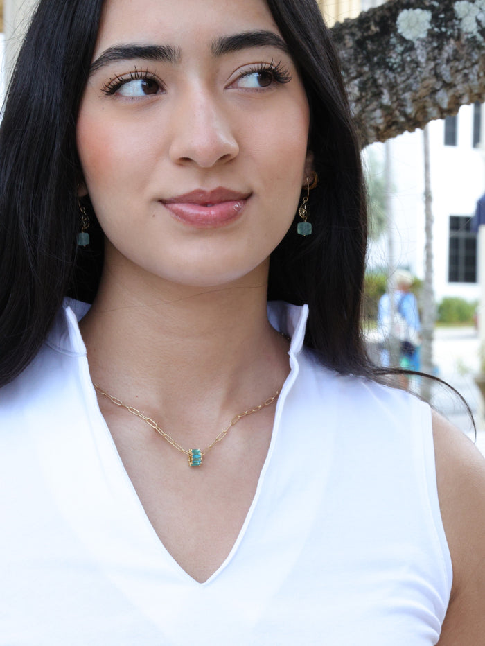 Aqua crystal rondel necklace on model paired with earrings from the nh Aqua gold collection