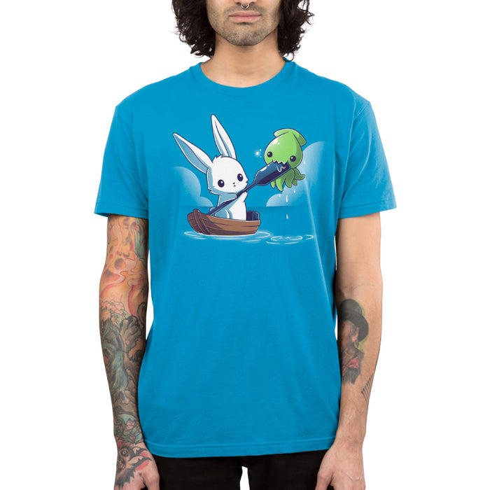 Premium Cotton T-shirt_TeeTurtle cobalt blue Baby Kraken Attack apparel featuring a baby kraken chomping on an oar being held by a bunny in a boat.