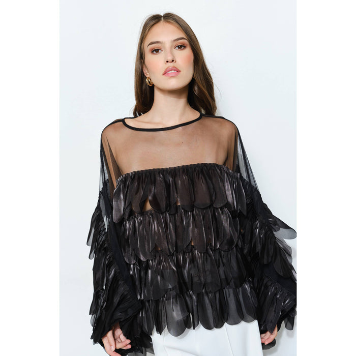 Black shimmer organza blouse with layered scalloped ruffles, a sheer mesh bodice, and wide ruffle sleeves.