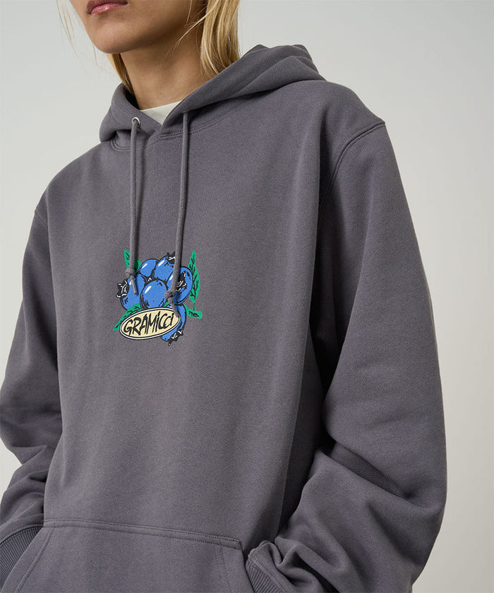 Gramicci Blueberry Hooded Sweatshirt with blueberry graphic in charcoal worn by a model against a light tone background.