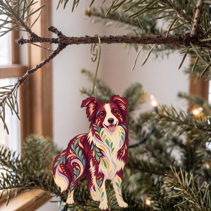 Laser-cut maple wood Border Collie folk art ornament O446 hanging on a fir branch, made in USA