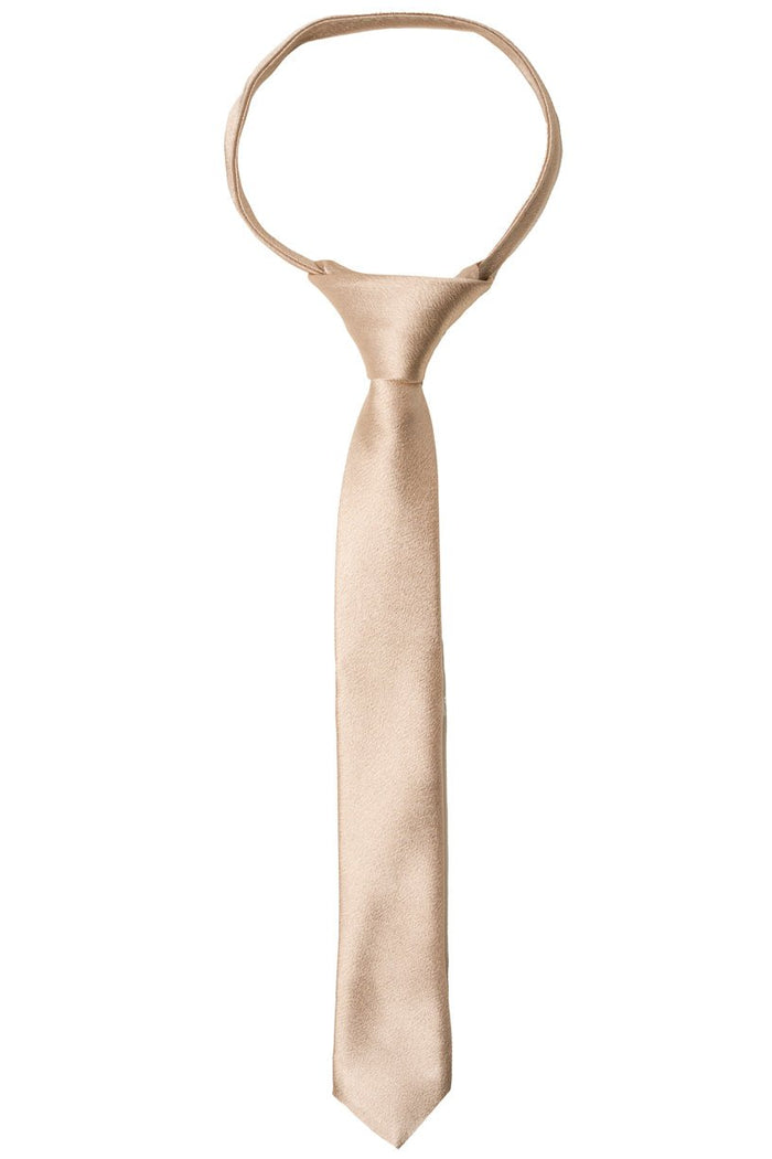 A refined Boys Max Tie in Champagne by Ivy City Co is styled with a classic knot and showcased against a crisp white backdrop, making this elegant beige accessory the ideal choice for weddings and formal events.