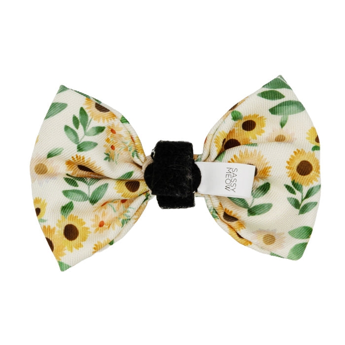 The Cat Bowtie - Sunflower Dreams by Sassy Woof features a sunflower and leaf design on cream, a black center band, and white Sassy Woof tag—ideal as an accessory or paired with a matching cat harness or collar.