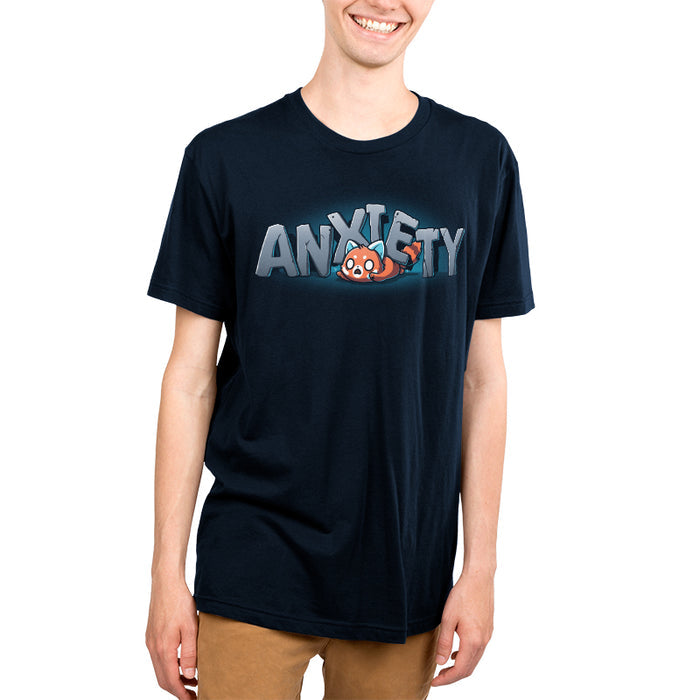 Premium Cotton T-shirt_TeeTurtle navy blue Crushing Anxiety featuring an anxious red panda being squished under giant letters made of stone that spell "Anxiety" on top of his body.