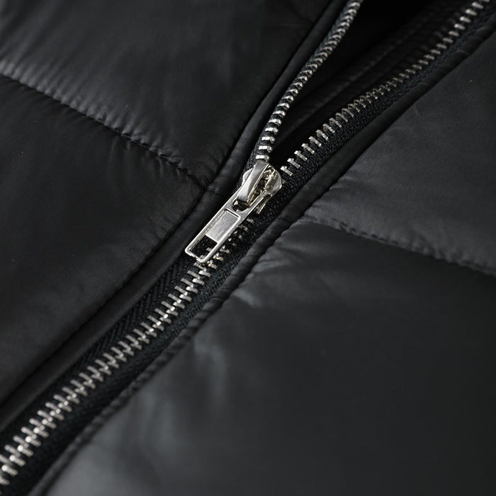 Close-up of a black jacket zipper with a silver zipper pull on a black background