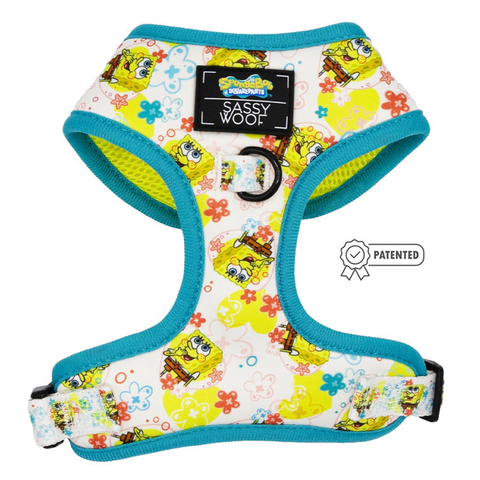 The Sassy Woof Dog Adjustable Harness – SpongeBob SquarePants™ Bikini Bottom features blue trim, a SpongeBob pattern, a central "Sassy Woof" label, metal leash ring, and a “Patented” icon. Part of our Puppy Growth Pawtection Plan.