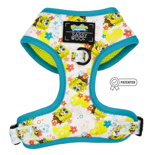 The Sassy Woof Dog Adjustable Harness – SpongeBob SquarePants™ Bikini Bottom features blue trim, a SpongeBob pattern, a central "Sassy Woof" label, metal leash ring, and a “Patented” icon. Part of our Puppy Growth Pawtection Plan.