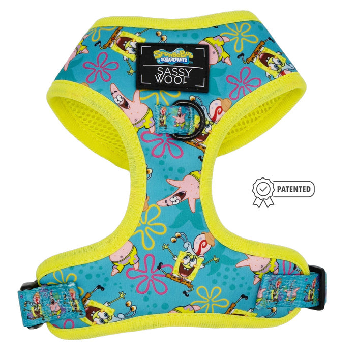 The Sassy Woof Dog Adjustable Harness - SpongeBob SquarePants™ Jelly Fishin' is turquoise and yellow, features SpongeBob and Patrick with pink flowers, a “Patented” badge, Sassy Woof label, and is part of the Puppy Growth Pawtection Plan.