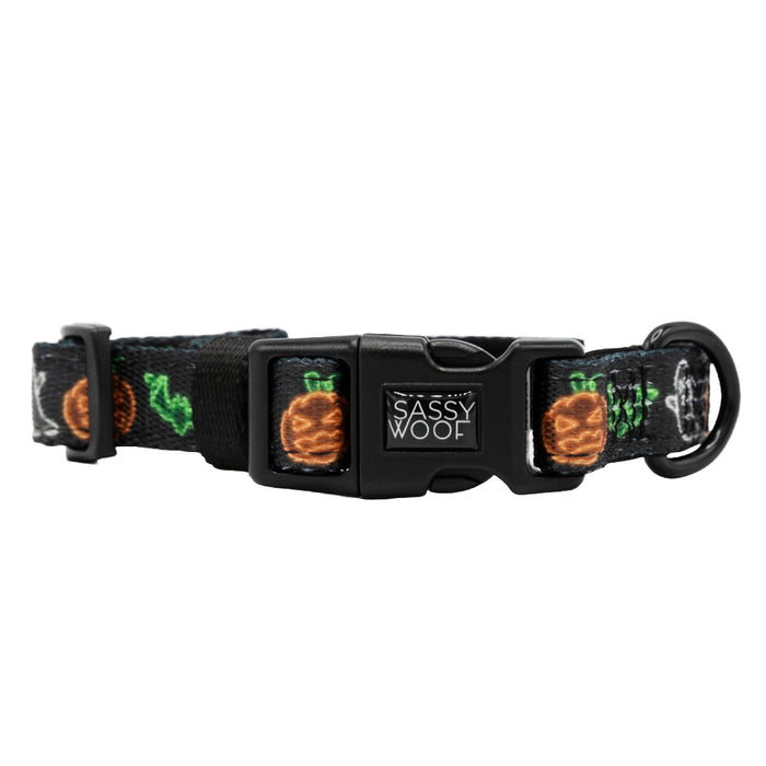 The Sassy Woof Dog Collar - Neon Frights is a black adjustable collar with a plastic buckle, featuring vibrant embroidered pineapples, green leaves, and “Sassy Woof” on the clasp—ideal for puppies with our Growth Pawtection Plan.