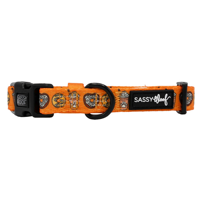 The Sassy Woof Dog Collar - Pupkin Donuts is an adjustable orange collar with a black buckle, D-ring, and fun donut print—ideal for fall dog accessories.