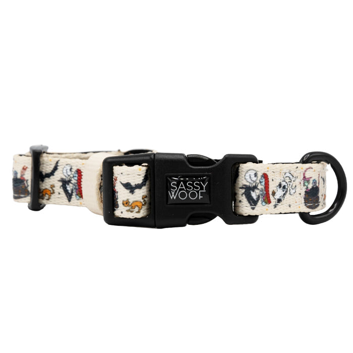 The Sassy Woof Dog Collar - The Nightmare Before Christmas™ (Beige) features playful dog designs, an adjustable fit, a black plastic buckle, and a sturdy black metal D-ring—perfect for pups on the Puppy Growth Pawtection Plan.