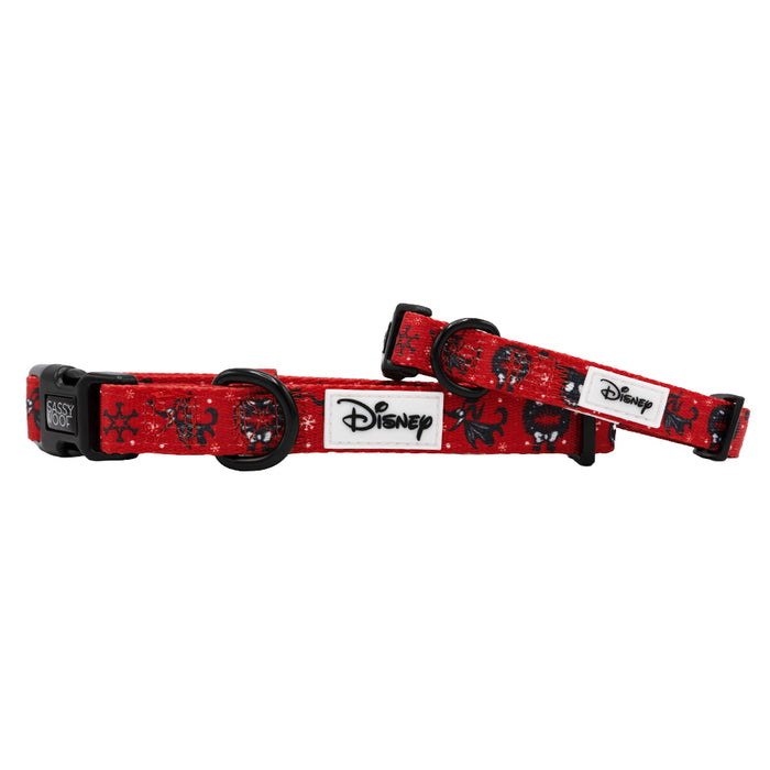 Two red Sassy Woof Dog Collar - The Nightmare Before Christmas™ lay flat and propped diagonally, featuring black buckles and rings, plus black-and-white character designs with snowflakes.