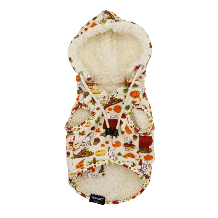 The Dog Reversible Sherpa Jacket - Peanuts™ Harvest by Sassy Woof is a soft white fleece coat with a vibrant fall Snoopy print, pumpkins, and autumn foods. It features two armholes and a small black label at the bottom.