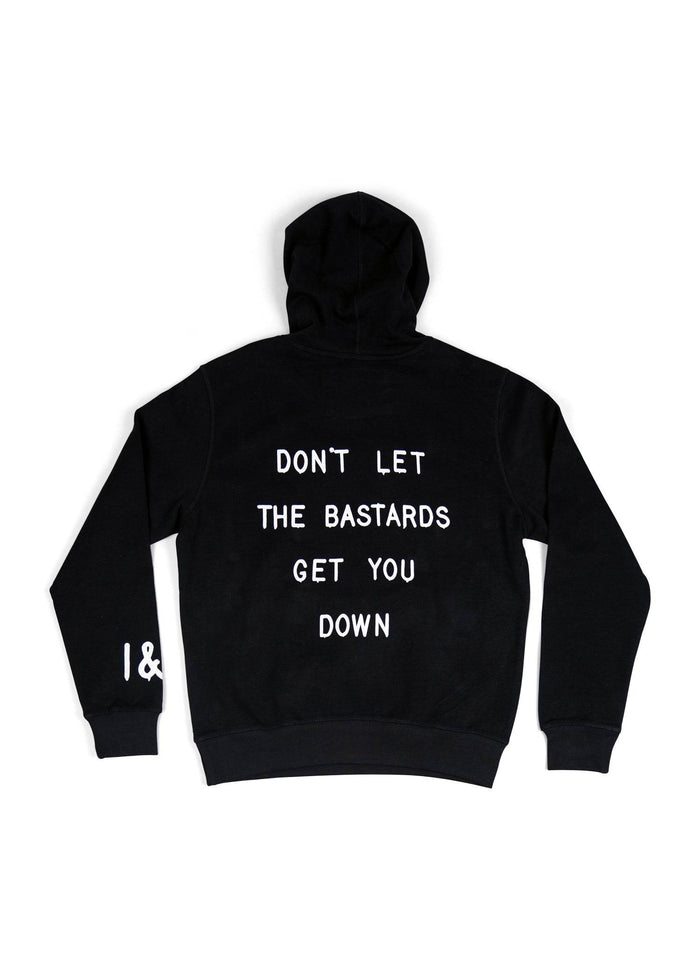 Black hoodie with bold white text saying, "DON'T LET THE BASTARDS GET YOU DOWN," covering the back. Simple and striking design.