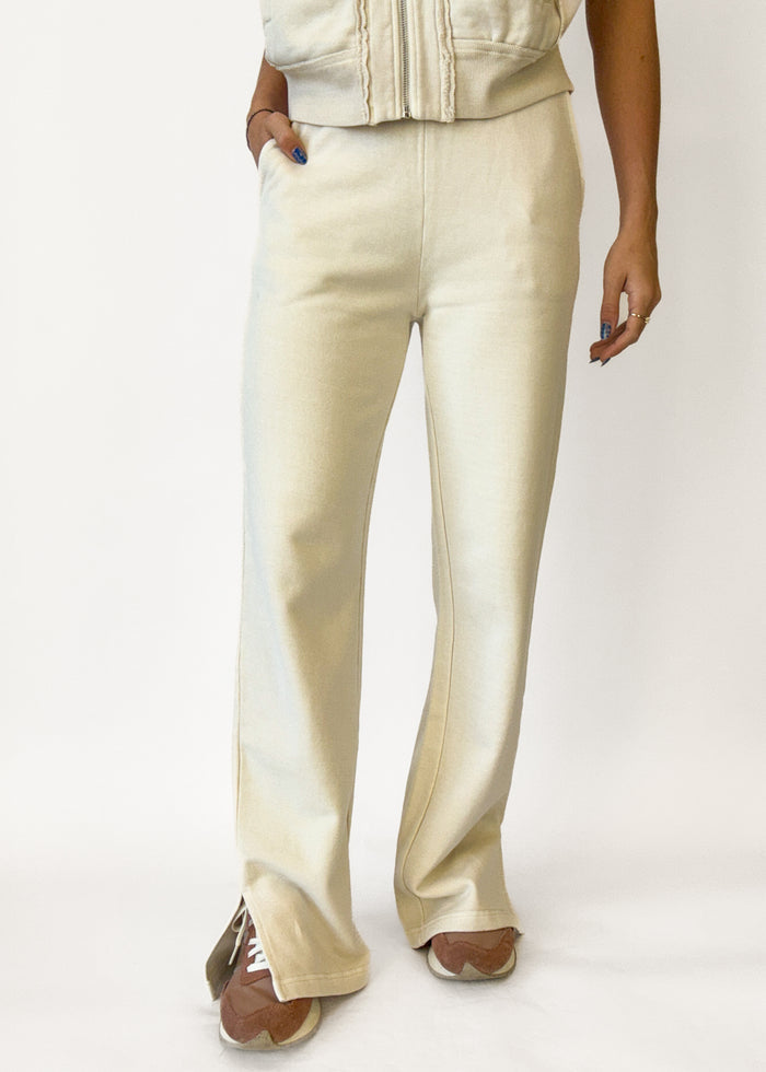 Person wearing beige pants on a white background