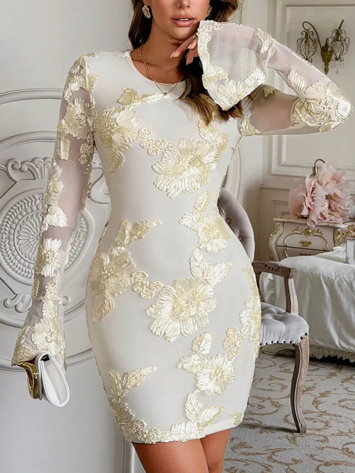 Close-up of floral embroidery on yellow mesh dress with open-back detail, long sleeves, lined body and mini length for women.