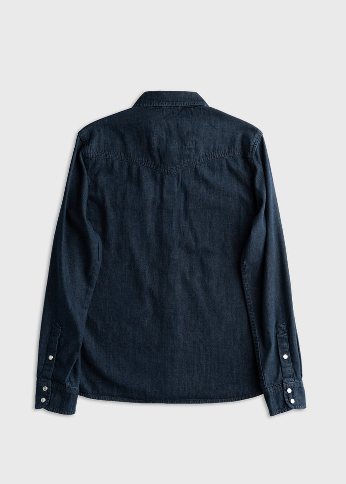 Dark denim long-sleeve shirt viewed from the back, featuring buttoned cuffs and a classic collar on a light gray background.