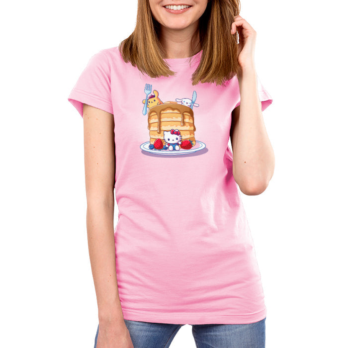 Premium Cotton T-shirt_TeeTurtle light pink Flapjacks and Friends apparel featuring Hello Kitty sitting in the middle of some strawberries and blueberries, Cinnamoroll holding a giant knife, and Pompompurin holding a giant fork with a giant stack of pancakes.