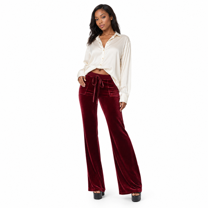 Close-up of micro-elastic polyester flared trousers, showing the subtle 3D texture, solid hue and flexible structured finish.