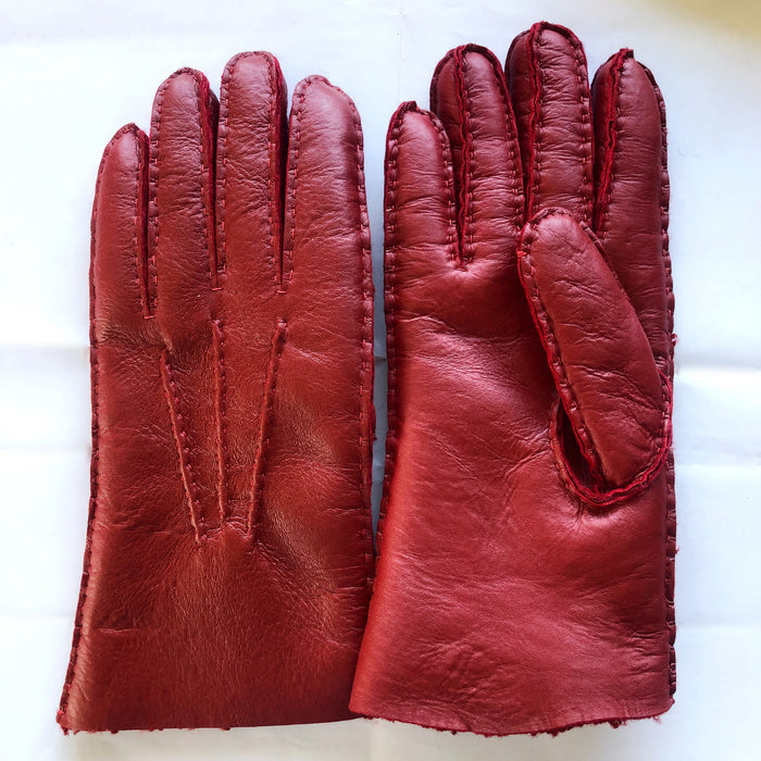 Two red coloured Four Peaks hand stitched women’s lambskin gloves.