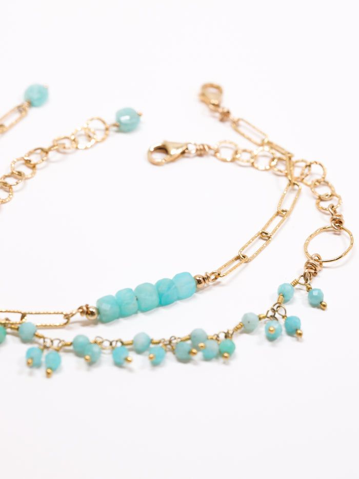 layering partner bracelets on flat lay. amazonite tiny stones and amazonite cube bracelet