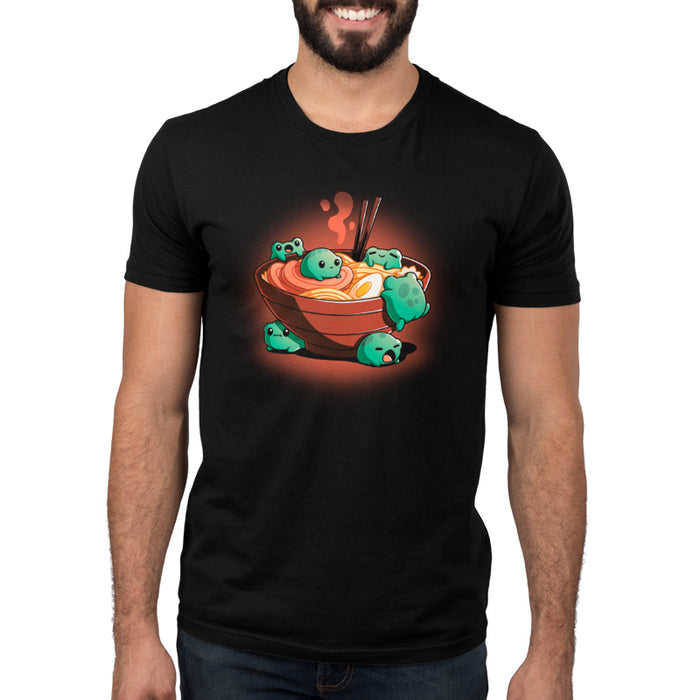 Premium Cotton T-shirt_TeeTurtle black Froggy Ramen apparel featuring a group of round green frogs in various playful poses around a steaming bowl of ramen.