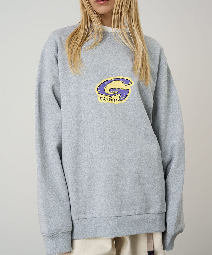Model wearing a Gramicci heather grey G-Scribble Sweatshirt with purple and yellow graphic against a light tone background.