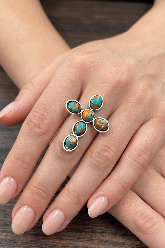 Natural gemstone cross statement ring with turquoise and earthy-toned stones, antique silver finish, and adjustable dual brass band.