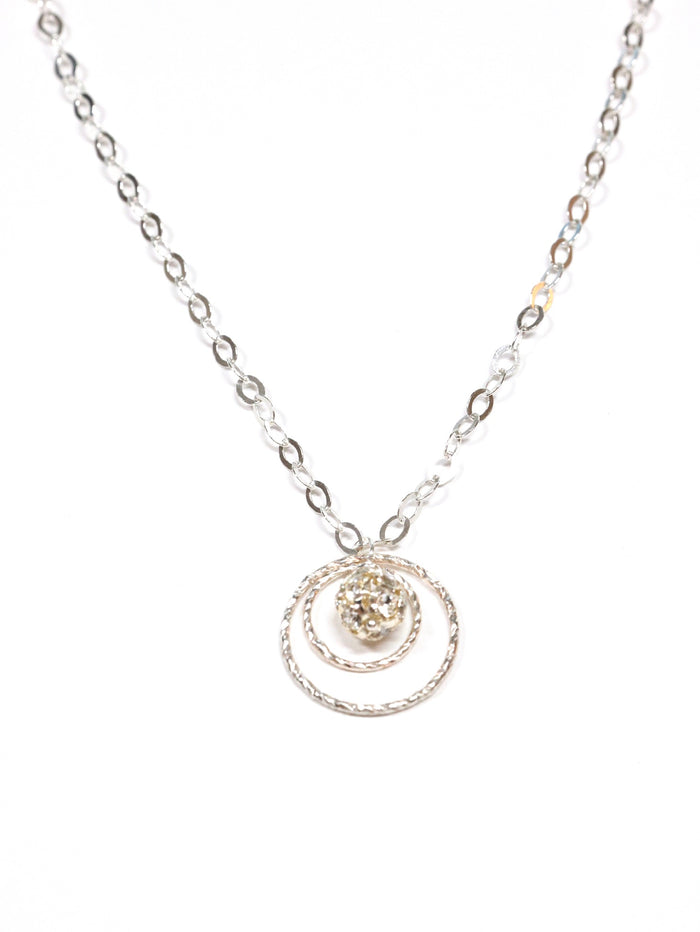 A sterling silver necklace with a swirled design pendant and a clear crystal drop in the center, displayed against a white background.