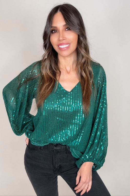 Hunter green V-neck sequin blouse top with allover sparkle, balloon sleeves, and elasticized cuffs.