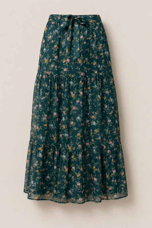 Add effortless elegance to your fall wardrobe with the Imogen Skirt in Evergreen Elysian Vine by Ivy City Co—a long, green maxi skirt crafted from soft, lightweight chiffon and adorned with a delightful pattern of small pink, yellow, and white flowers with green leaves. This tiered floral skirt features a comfortable drawstring waist for an easy, flattering fit.