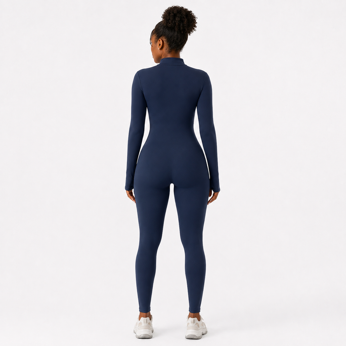 Navy Blue one-piece activewear jumpsuit shown from the back with long sleeves, mock neck and a fitted full-length silhouette.