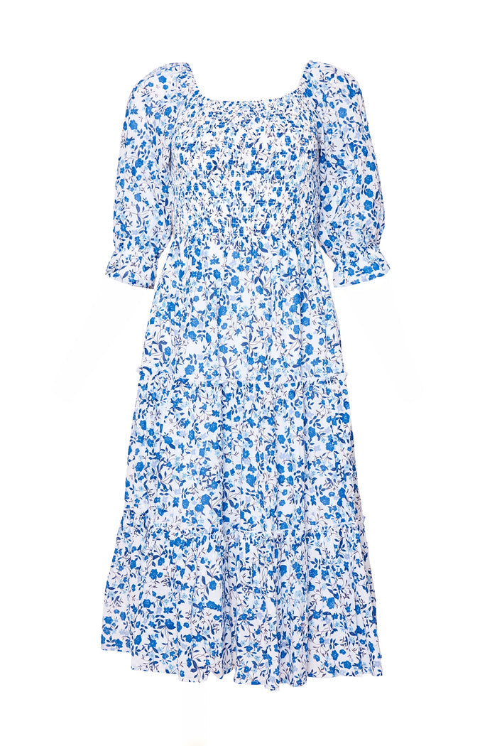 The Madeline Dress in Ditsy Cobalt Floral by Ivy City Co features blue and white cotton, puffed half sleeves, a square neckline, tiered skirt, and a shirred bodice for comfort—perfect as a maternity friendly dress.