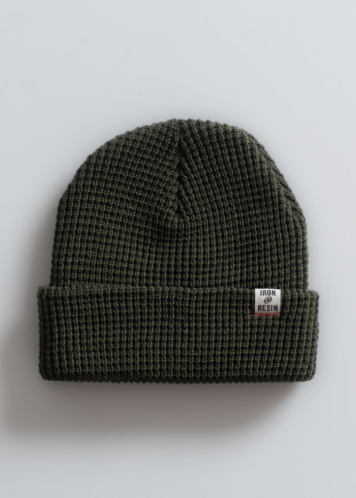 Dark green waffle-knit beanie with "Iron and Resin" label on the cuff, displayed on a plain white background.