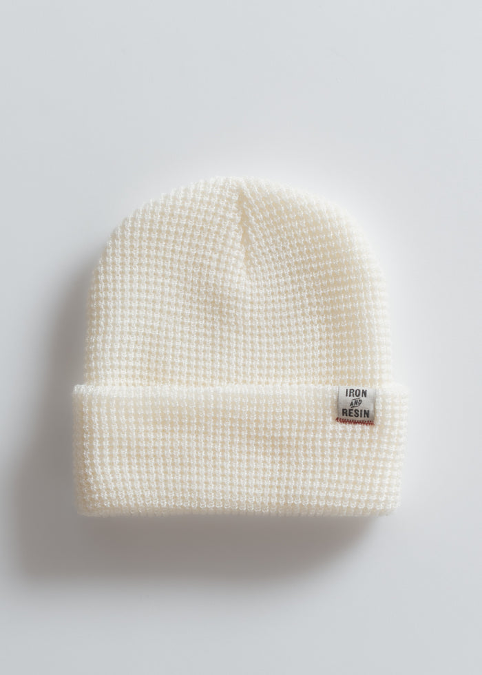 Cream waffle-knit beanie with a folded brim and "Iron and Resin" label, set against a plain white background.