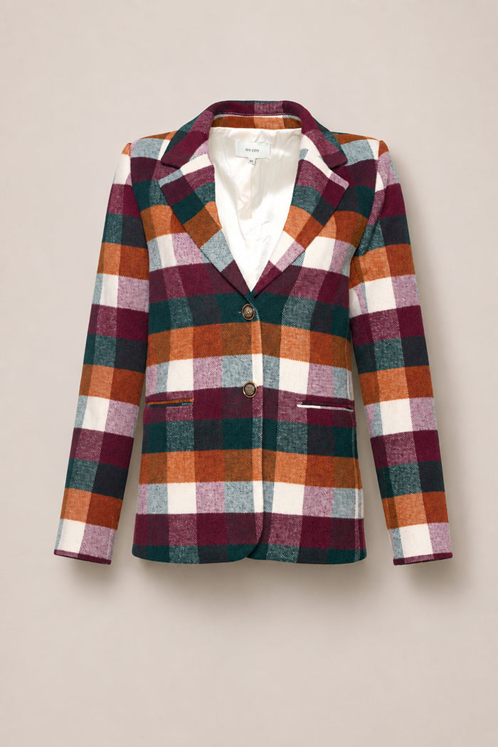 Introducing the Marren Blazer in Maize Brushed Gingham by Ivy City Co—a tailored women’s blazer showcasing a vibrant plaid pattern in green, burgundy, orange, gray, and white. Designed with two front buttons and slit pockets, this blazer is expertly crafted from a luxurious wool-blend fabric for elevated style and comfort.