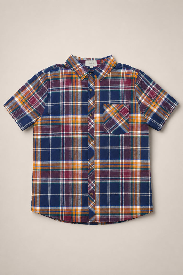 The Mens James Shirt in Midnight Plaid by Ivy City Co is a short-sleeve, button-up cotton shirt showcasing a blue, orange, red, and white plaid pattern with a single chest pocket—an easy essential for any fall wardrobe, pictured laid flat on a neutral background.