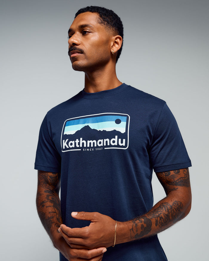 b0995_893_mens_kathmandu_logo_70s_organic_cotton_tshirt_a_1768348924000