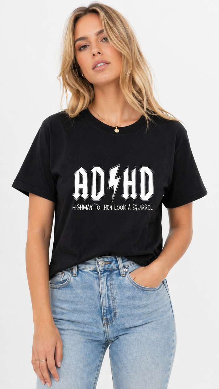 Person wearing a black t-shirt with 'ADHD' text and lightning bolt graphic.