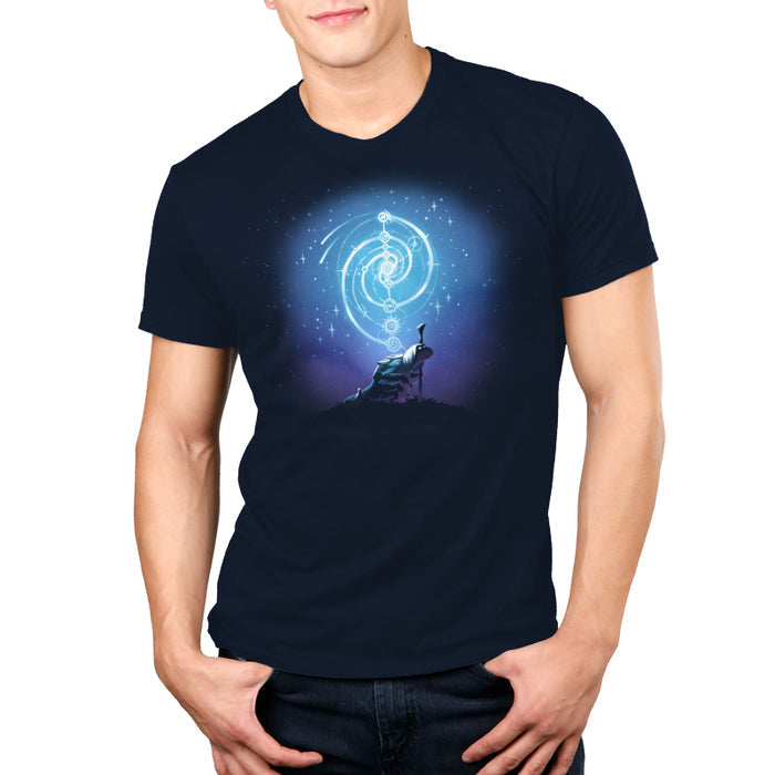 Premium Cotton T-shirt_TeeTurtle navy blue Mystical urRu apparel featuring an urRu holding a staff on a hilltop looking into the distance with mystical celestial circular patterns above it against a starry background.