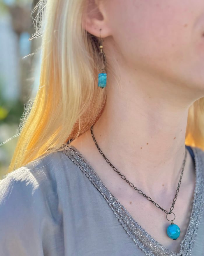 Model wearing Ocean Jasper natural brass dangle earrings by Nina Halls