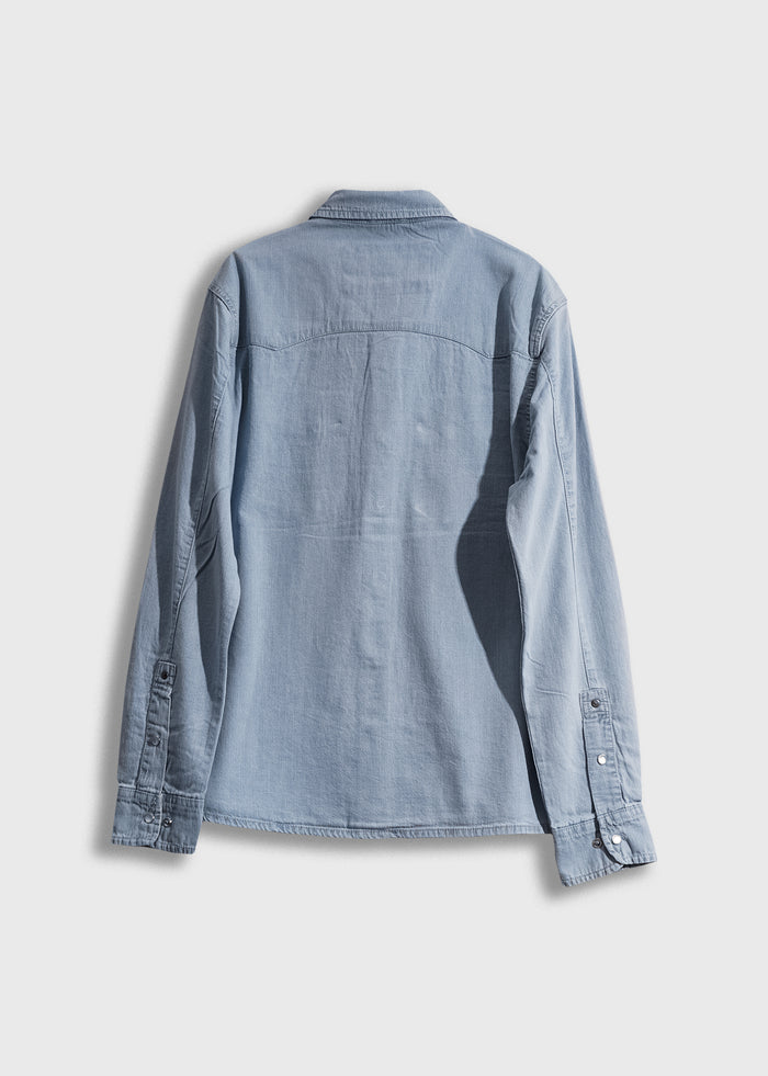 Light blue denim shirt with long sleeves and buttoned cuffs, shown from the back against a plain white background.
