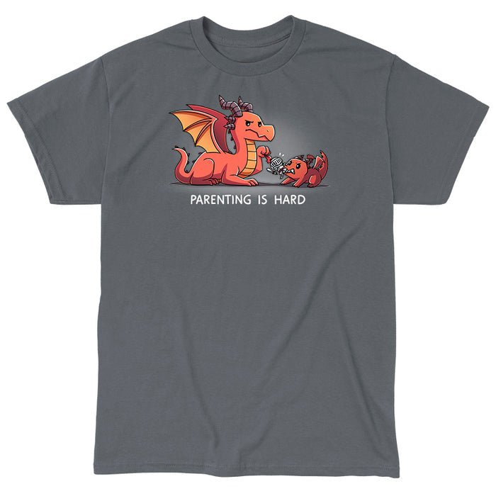 Classic Cotton T-shirt_TeeTurtle charcoal gray Parenting is Hard apparel featuring a parent dragon holding onto a toy knight while its baby dragon grabs it with its mouth.