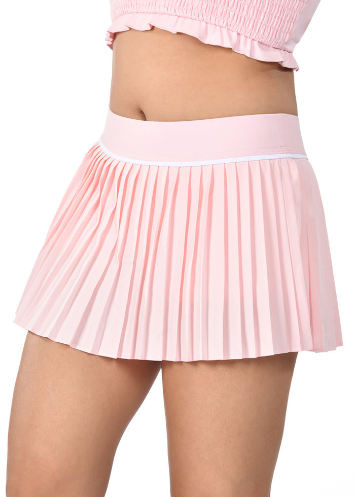 Pink pleated skirt worn by a person on a white background
